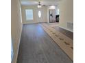 Open-concept living room with luxury vinyl plank flooring and a ceiling fan at 1107 Howard St, Clearwater, FL 33756