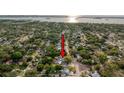 Aerial view of the neighborhood, highlighting the home's location near the water with lush surrounding trees at 1267 Woodlawn Ter, Clearwater, FL 33755