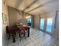 Cozy dining room area with chandelier lighting and sliding glass doors to the patio at 12912 Leadwood Dr, Riverview, FL 33579