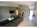 Spacious living area with tile flooring, vaulted ceiling, and neutral gray walls at 12912 Leadwood Dr, Riverview, FL 33579
