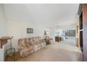 Open-concept living room featuring neutral colors, ceiling fan, and lots of natural light at 13563 Cordova Dr, Largo, FL 33774