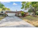 Beautiful home with a long driveway, an attached two-car garage, and well maintained landscaping at 14000 104Th Ave, Largo, FL 33774