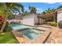 Backyard pool and hot tub with brick surround, pergola and outdoor seating at 1436 30Th N Ave, St Petersburg, FL 33704