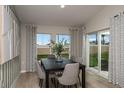 Dining area features stylish decor, hardwood floors, and a sliding glass door leading to the backyard at 14815 Summer Branch Dr, Lithia, FL 33547