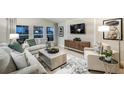 Cozy living room with neutral tones, plush seating, large windows, and contemporary decor at 14815 Summer Branch Dr, Lithia, FL 33547
