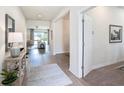 Bright foyer with light wood floors, modern decor, and an open view to the living space at 1512 Banner Elk St, Valrico, FL 33594