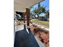 Inviting front porch with tiled floor and decorative landscaping at 1778 New Hampshire Ne Ave, St Petersburg, FL 33703