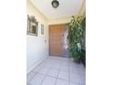 Inviting front door with sidelight, tiled entry, and decorative mirror at 2211 Bay Berry Ln, Clearwater, FL 33763