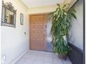Welcoming front door with sidelight, tiled entry, and decorative mirror at 2211 Bay Berry Ln, Clearwater, FL 33763
