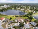 Stunning aerial view of a lakefront home with lush landscaping and a private pool at 2333 Camp Indianhead Rd, Land O Lakes, FL 34639