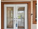 Elegant glass front door with decorative detailing and visible smart doorbell at 2421 Lake Point Ln, Clearwater, FL 33762