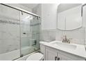 Updated bathroom with marble tile, glass shower door, and modern fixtures, enhancing comfort at 2469 Franciscan Dr # 59, Clearwater, FL 33763