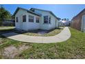 Cozy single-story home with sidewalk, and some grass at 2510 Queen S St, St Petersburg, FL 33712