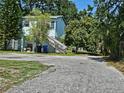 Two-story home with a backyard, stairs and gravel at 2510 Queen S St, St Petersburg, FL 33712