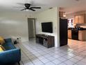 Bright living room featuring tile flooring, a ceiling fan, and a view into the kitchen at 2701 47Th N Ave, St Petersburg, FL 33714