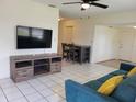 Bright living room features large windows, tile floors, a ceiling fan and an entertainment center at 2701 47Th N Ave, St Petersburg, FL 33714