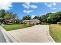 Wide driveway leading to a well-kept single-story home with lush landscaping at 2811 Barret Ave, Plant City, FL 33566