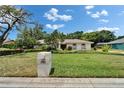 Well-manicured lawn and landscaped front yard with mailbox on a sunny day at 2811 Barret Ave, Plant City, FL 33566