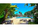 Community pool area featuring inviting lounge chairs and a gazebo with lush landscaping at 3907 Orchard Hill Cir, Palm Harbor, FL 34684