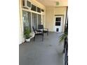 Inviting patio area with comfortable chairs and a small table; potted plant adds a natural touch at 4051 58Th N St # 241C, Kenneth City, FL 33709