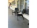 Relaxing patio with comfortable chairs and a small table, perfect for enjoying the outdoors at 4051 58Th N St # 241C, Kenneth City, FL 33709