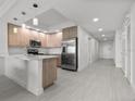 Bright kitchen with stainless steel appliances, light cabinetry, and easy access to living area at 415 Island Way # 303, Clearwater Beach, FL 33767