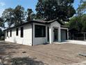 Charming single-story home with a fresh exterior, landscaping potential, and black trim at 4241 E Palifox St, Tampa, FL 33610