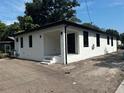 The exterior features black trim windows and a covered porch at 4241 E Palifox St, Tampa, FL 33610