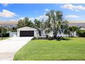 Well-manicured lawn and landscaped garden in front of a one-story brick home at 4618 Bayshore Ne Blvd, St Petersburg, FL 33703