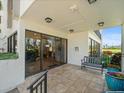 Covered building entrance with glass doors, bench seating and tropical landscaping at 5700 Escondida S Blvd # 401, St Petersburg, FL 33715