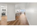 Bright hallway showcasing hardwood flooring, leading to the dining area and kitchen at 5700 Escondida S Blvd # 401, St Petersburg, FL 33715