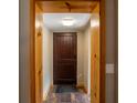 Warm wooden front door with rustic trim and hardwood floors, ready for your personal touch at 6726 Udell Ln, Hudson, FL 34667