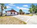 Cozy single-story home with a spacious driveway and simple landscaping at 6915 N Hubert Ave, Tampa, FL 33614