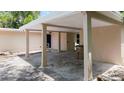 Covered carport featuring stone accent wall detail, with access to home at 810 W River Dr, Temple Terrace, FL 33617
