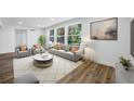 Bright living room with hardwood floors, contemporary furniture, and large windows providing natural light at 810 W River Dr, Temple Terrace, FL 33617