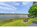 Scenic lake view with bench seating, perfect for relaxation and enjoying the outdoors at 9602 Lake Chase Island Way # 9602, Tampa, FL 33626
