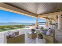 Inviting outdoor patio overlooking ocean with comfortable seating at 100 Sands Point Dr, Tierra Verde, FL 33715