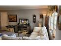 Comfortable living room with neutral colors, cozy seating, and natural light through the window at 10040 38Th N Way, Pinellas Park, FL 33782