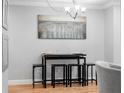 Dining area featuring modern chandelier and bar-height seating for flexible dining at 11901 4Th N St # 8207, St Petersburg, FL 33716