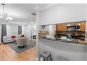 Open-concept living area with modern fireplace and kitchen bar with granite countertop at 11901 4Th N St # 8207, St Petersburg, FL 33716