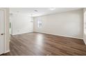 Spacious living room featuring hard surface floors, neutral paint, and ample natural light at 12212 Mcmullen Loop, Riverview, FL 33569