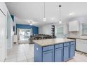 Open-concept kitchen with granite island, stainless appliances, and seamless flow into the living area at 13404 Fladgate Mark Dr, Riverview, FL 33579