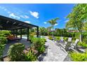 An outdoor oasis with a pool, fire pit, and covered patio perfect for entertaining at 13916 Wellesford Way, Tampa, FL 33624