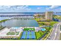Amazing aerial view of the community's amenities including the marina, pool, tennis courts, and clubhouse, all with water views at 140 Riviera Dunes Way # 1203, Palmetto, FL 34221
