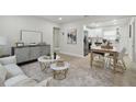 Open concept living room featuring stylish decor and a seamless flow to the modern kitchen at 1404 E Curtis St, Tampa, FL 33603