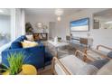Stylish living room with modern decor, a blue sofa, and bright lighting at 14626 Wildwood Dr, Largo, FL 33774