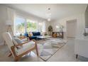Bright and airy living room with large windows, modern furniture, and open layout at 14626 Wildwood Dr, Largo, FL 33774