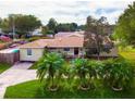 Features a well-kept lawn, beautiful palm trees, and a neatly paved driveway at 1500 Ohio Ne Ave, St Petersburg, FL 33703