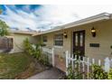 The house features neat landscaping, a white picket fence, and decorative outdoor lighting at 1500 Ohio Ne Ave, St Petersburg, FL 33703