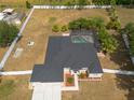 Aerial view of a property featuring a spacious backyard with a screened-in pool and surrounding greenery at 1521 Avondale Ridge Dr, Plant City, FL 33567